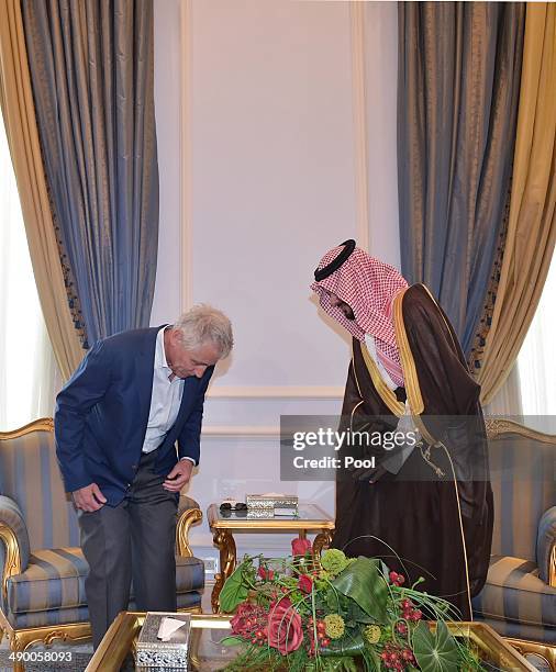 Defense Secretary Chuck Hagel and Saudi Deputy Defense Minister Salman bin Sultan take their seats for a bilateral meeting in a terminal of King...