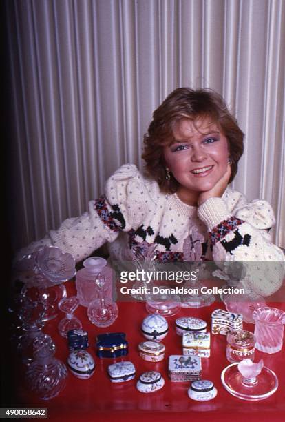 Actress Jill Whelan poses for a portrait session at home with a collection of glass boxes in 1985 in Los Angeles, California.
