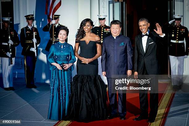 President Barack Obama, from right, waves as he stands for photographs with Xi Jinping, China's president, U.S. First Lady Michelle Obama and Peng...