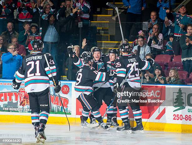 Devante Stephens, Dillon Dube, Tyson Baillie, Riley Stadel and Cal Foote celebrate the first goal of the regular season during the first period of...