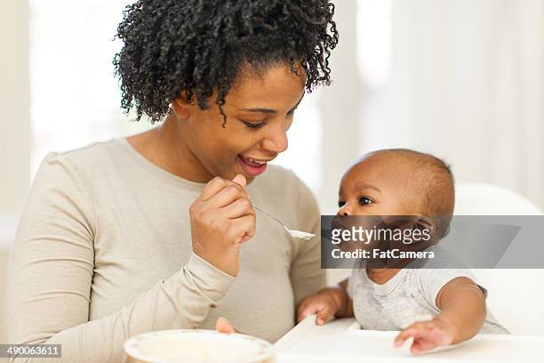 feeding baby - feeding baby stock pictures, royalty-free photos & images