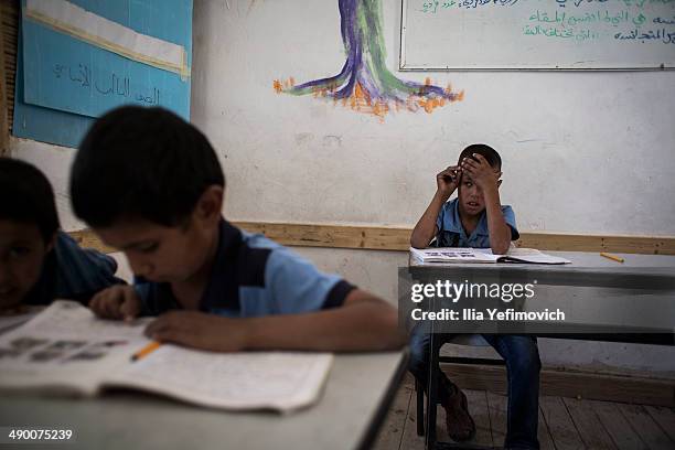 Pupils take part in a classroom activity at a Palestinian Bedouin of Jahaline tribe school in the area of E1, not far from the settlement of Maale...