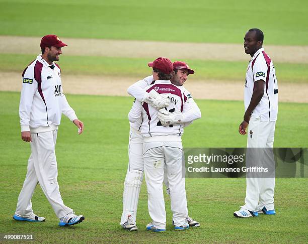 Robert Newton of Northamptonshire is congratuated by David Murphy on catching Samit Patel of Nottinghamshire during day three of the LV County...