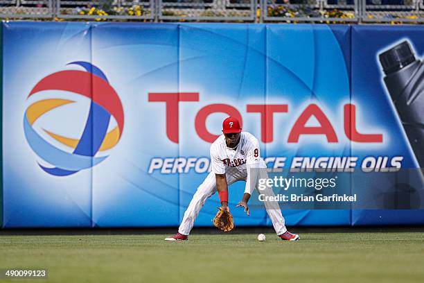 Domonic Brown of the Philadelphia Phillies fields the ball during the game against the Miami Marlins at Citizens Bank Park on April 12, 2014 in...