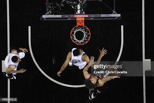 Robin Lopez of the Portland Trail Blazers battles Tim Duncan of the San Antonio Spurs for a rebound in Game Two of the Western Conference Semifinals...
