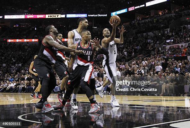 Tony Parker of the San Antonio Spurs shoots over Damian Lillard of the Portland Trail Blazers in Game Two of the Western Conference Semifinals during...