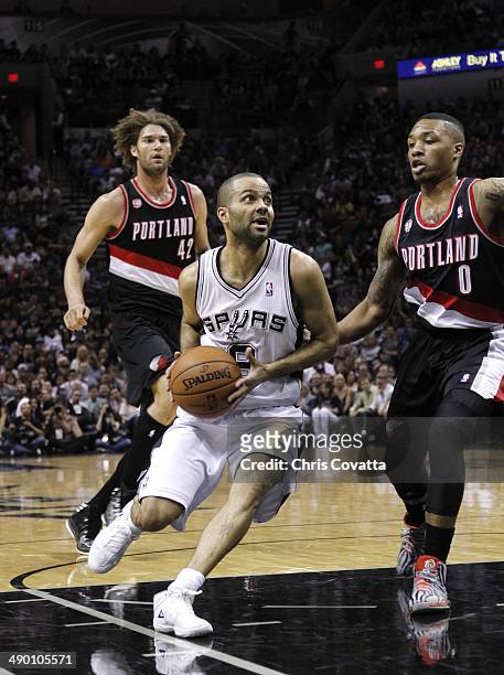 Tony Parker of the San Antonio Spurs moves into the lane against Damian Lillard of the Portland Trail Blazers in Game Two of the Western Conference...