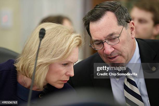Senate Agriculture Committee member Sen. Kristen Gillibrand and Sen. Joe Donnelly talk during a hearing in the Russell Senate Office Building May 13,...
