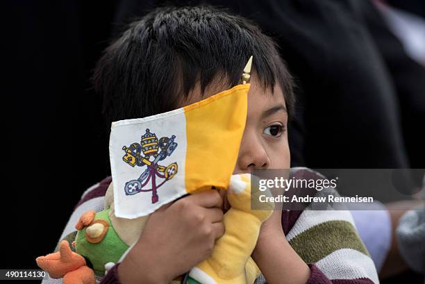 Boy waits for Pope Francis with a Vatican Flag prior to the Pope's departure from New York at John F. Kennedy International Airport on September 26,...