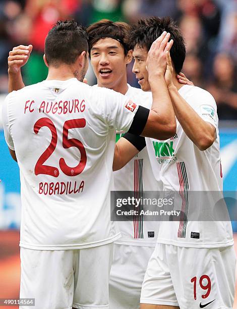 Ja-Cheol Koo of Augsburg is congratulated by Jeong-Ho Hong after scoring a goal during the Bundesliga match between FC Augsburg and 1899 Hoffenheim...