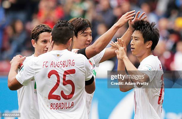 Ja-Cheol Koo of Augsburg is congratulated by Jeong-Ho Hong after scoring a goal during the Bundesliga match between FC Augsburg and 1899 Hoffenheim...