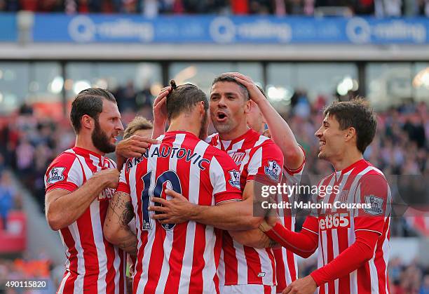 Jonathan Walters of Stoke City celebrates scoring his team's first goal with his team mates during the Barclays Premier League match between Stoke...