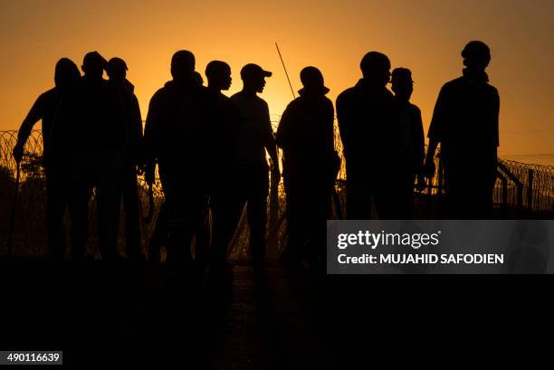 Striking miners demonstrate in Marikana, 40 kms away from Rustenburg, in the South African platinum belt on May 13, 2014. Three mine workers were...