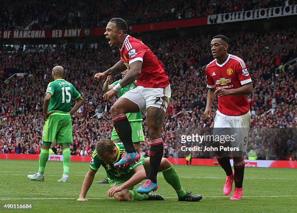 Memphis Depay of Manchester United celebrates scoring their first goal during the Barclays Premier League match between Manchester United and...