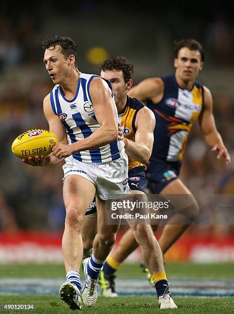 Ben Jacobs of the Kangaroos handballs during the AFL Second Preliminary Final match between the West Coast Eagles and the North Melbourne Kangaroos...