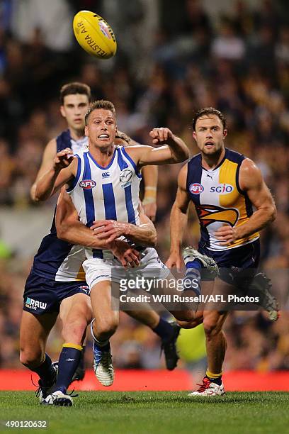 Andrew Swallow of the Kangaroos is tackled by Matt Priddis of the Eagles during the AFL Second Preliminary Final match between the West Coast Eagles...