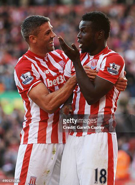 Mame Biram Diouf of Stoke City celebrates scoring his team's second goal with his team mate Jonathan Walters during the Barclays Premier League match...