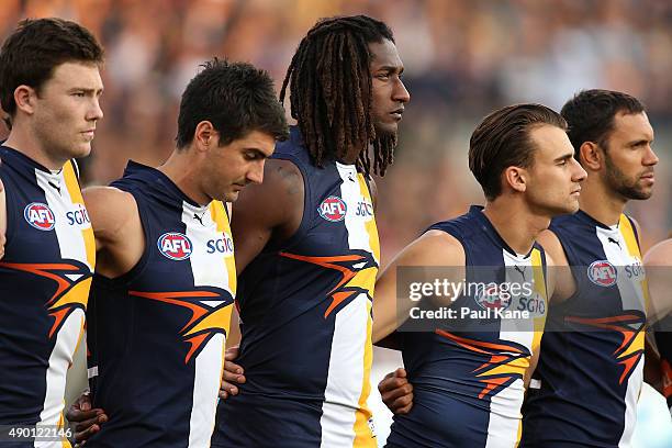 Nic Naitanui of the Eagles looks on with team mate for the national anthem during the AFL Second Preliminary Final match between the West Coast...