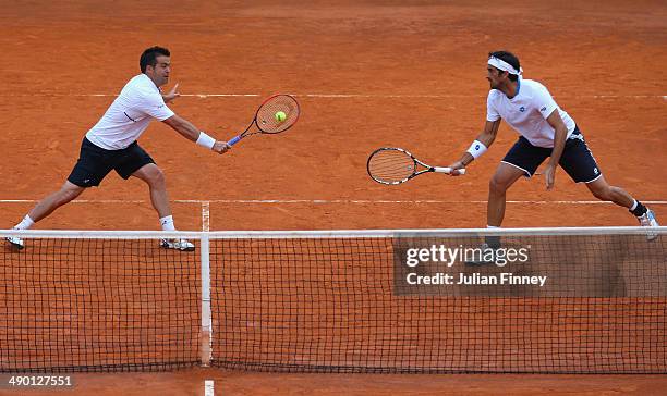 Daniele Bracciali of Italy and Potito Starace of Italy in action in the doubles against Max Mirnyi of Belarus and Mikhail Youzhny of Russia during...