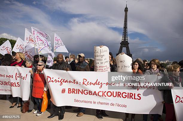 People hold placards reading "Bring back our girls" during a demonstration to press for the release of the Nigerian schoolgirls held hostage by the...