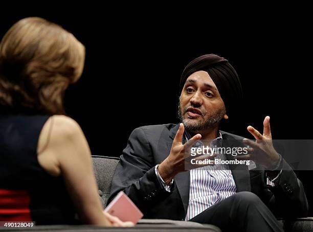 Hardeep Walia, co-founder and chief executive officer of Motif Investing Inc., right, speaks during the 2014 WIRED Business Conference in New York,...