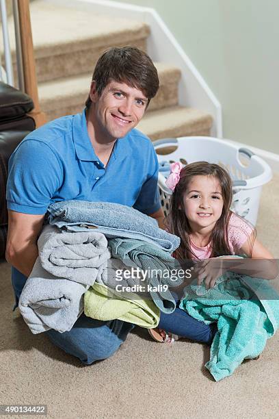 father and daughter folding laundry - man washing basket child stock pictures, royalty-free photos & images