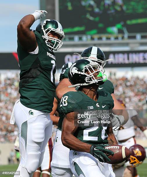 Madre London of the Michigan State Spartans scores on a short run during the first quarter of the game against the Central Michigan Chippewas on...