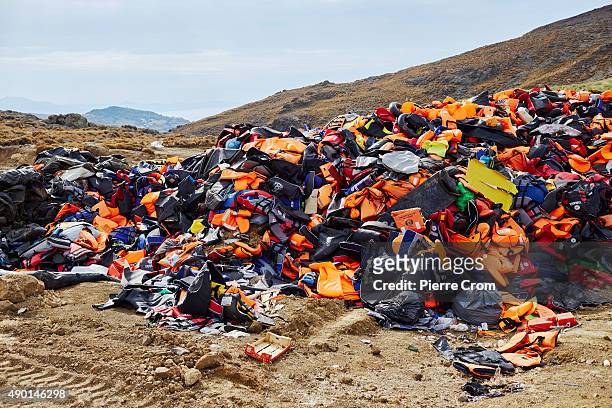 Thousands of life jackets and remains of rubber boats are collected as refugees and migrants arrive ashore on the Greek island of Lesbos from Turkey...