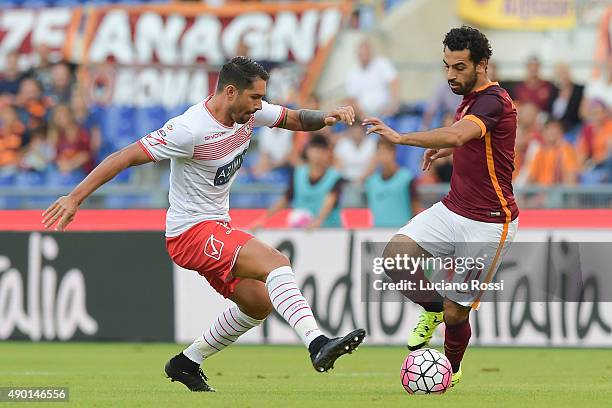 Roma player Mohamed Salah is challenged by Carpi FC player Marco Borriello during the Serie A match between AS Roma and Carpi FC at Stadio Olimpico...