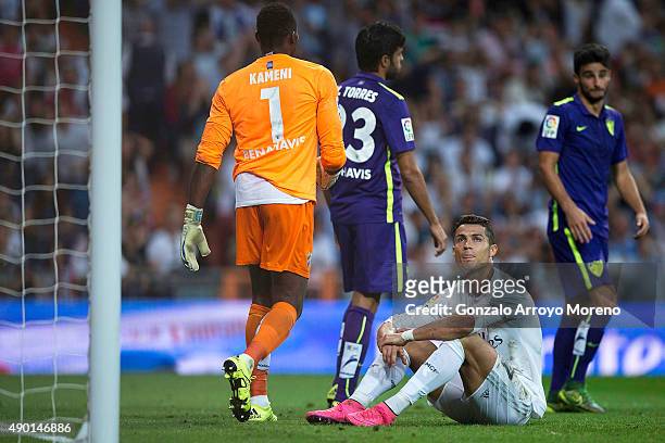 Cristiano Ronaldo of Real Madrid CF reacts as he fail to score close to goalkeeper Idriss Carlos Kameni of Malaga CF and his teammate Miguel Torres...