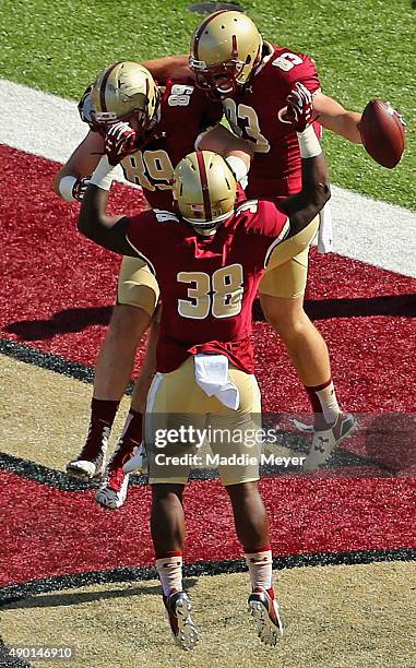 Charlie Callinan of the Boston College Eagles celebrates wiht Richard Wilson and Tommy Sweeney after scoring a touchdown against the Northern...