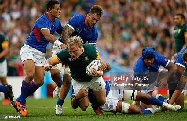 Adriaan Strauss of South Africa is tackled by Teofilo Paulo of Samoa during the 2015 Rugby World Cup Pool B match between South Africa and Samoa at...
