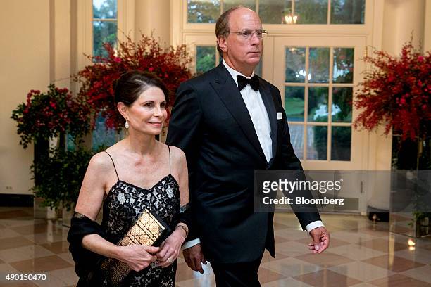 Laurence "Larry" Fink, chief executive officer of BlackRock Inc., right, and Lori Fink arrive at a state dinner in honor of Chinese President Xi...