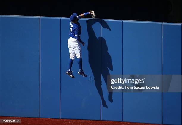Kevin Pillar of the Toronto Blue Jays climbs the wall but cannot get to a solo home run hit by Kevin Kiermaier of the Tampa Bay Rays in the fourth...