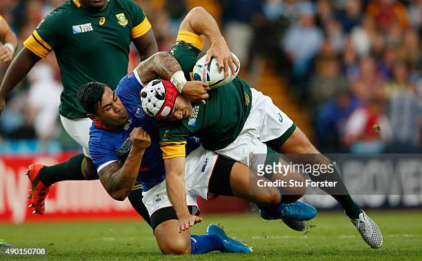 Schalk Brits of South Africa is tackled by Tusi Pisi of Samoa during the 2015 Rugby World Cup Pool B match between South Africa and Samoa at Villa...