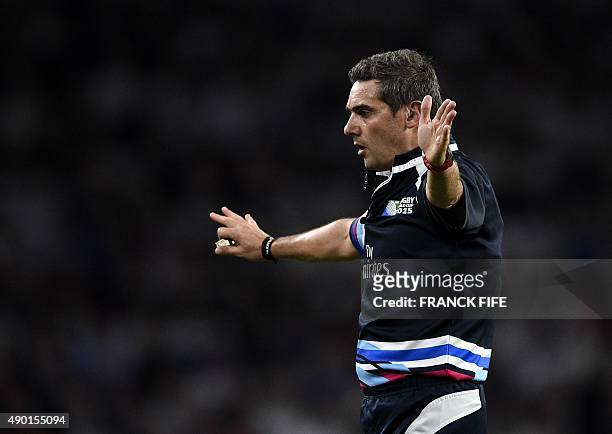 French referee Jerome Garces gestures during a Pool A match of the 2015 Rugby World Cup between England and Wales at Twickenham stadium, south west...