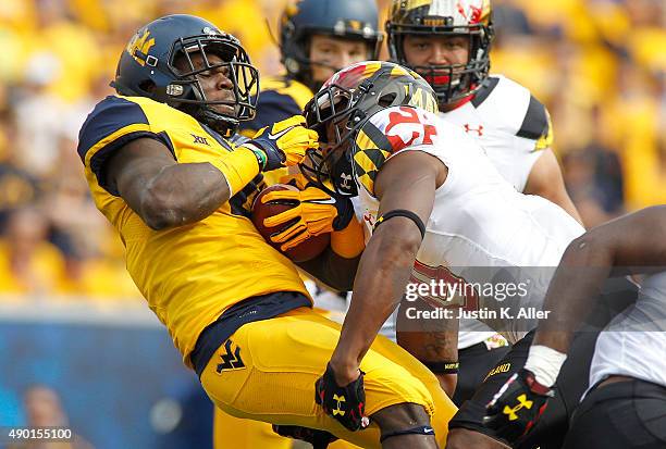 Rushel Shell of the West Virginia Mountaineers is tackled by A.J. Hendy of the Maryland Terrapins in the first quarter during the game on September...