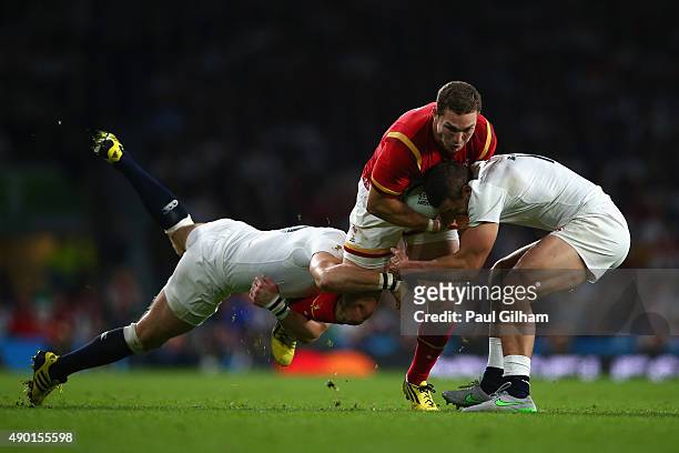George North of Wales is tackled by Mike Brown and Jonny May of England during the 2015 Rugby World Cup Pool A match between England and Wales at...
