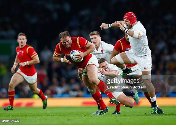 Jamie Roberts of Wales is tackled by Sam Burgess of England during the 2015 Rugby World Cup Pool A match between England and Wales at Twickenham...
