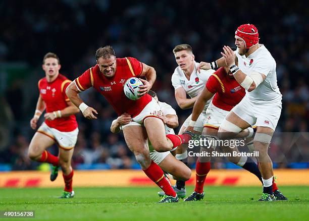 Jamie Roberts of Wales is tackled by Sam Burgess of England during the 2015 Rugby World Cup Pool A match between England and Wales at Twickenham...