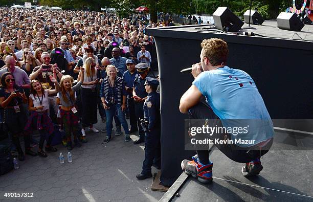 Chris Martin performs with Coldplay onstage while Apple Martin and Moses Martin watch from the crowd during 2015 Global Citizen Festival to end...