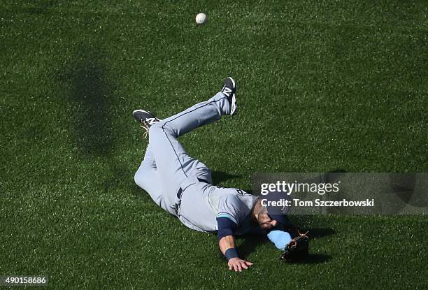 Kevin Kiermaier of the Tampa Bay Rays slides but cannot get to an RBI double hit by Kevin Pillar of the Toronto Blue Jays in the third inning during...