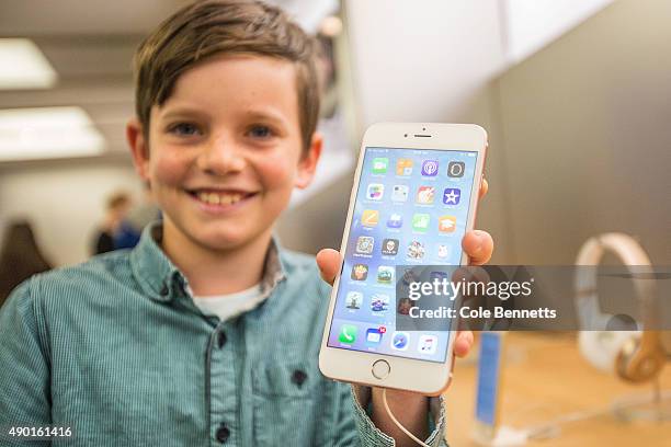 Levi aged 10, shows of the new iPhone 6s Plus in rose gold as crowds wait in anticipation for the release of the iPhone 6s and 6s Plus at Apple Store...