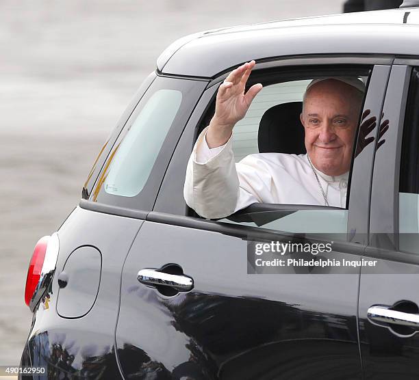 Pope Francis waves from his Fiat as he leaves Atlantic Aviation in Philadelphia on Saturday, Sept. 26, 2015.