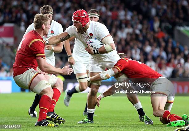 James Haskell hands off Bradley Davies of Wales during the 2015 Rugby World Cup Pool A match between England and Wales at Twickenham Stadium on...