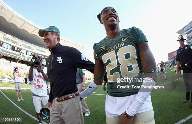 Head coach Art Briles of the Baylor Bear celebrates with Devin Chafin of the Baylor Bears after the Bears beat the Rice Owls 70-17 at McLane Stadium...