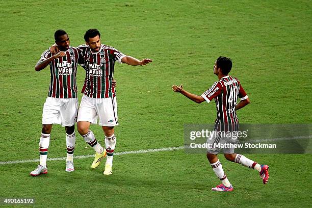 Gerson and Fred of Fluminense celebrate with Gustavo Scarpa ater his goal against Goias during a match between Fluminense and Goias as part of...