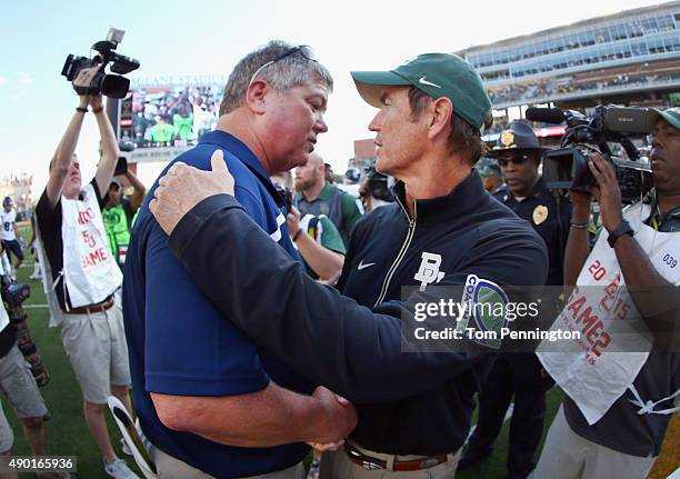 Head coach David Bailiff of the Rice Owls greets head coach Art Briles of the Baylor Bears after the Bears beat the Owls 70-17 at McLane Stadium on...