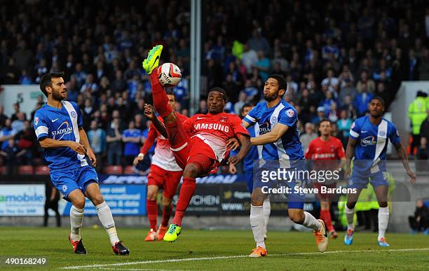 Kevin Lisbie of Leyton Orient challenges for the ball with Nathaniel Knight-Percival of Peterborough United during the Sky Bet League One play-off...