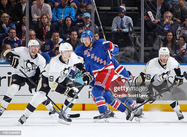 Derek Stepan of the New York Rangers skates against Joe Vitale, Paul Martin and Beau Bennett of the Pittsburgh Penguins in Game Three of the Second...